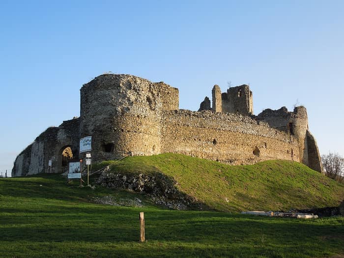 Ruins of Jasenov Castle on its wooded hill above the village of Jasenov